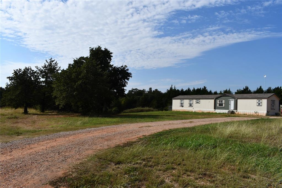 View of front of home with dirt driveway