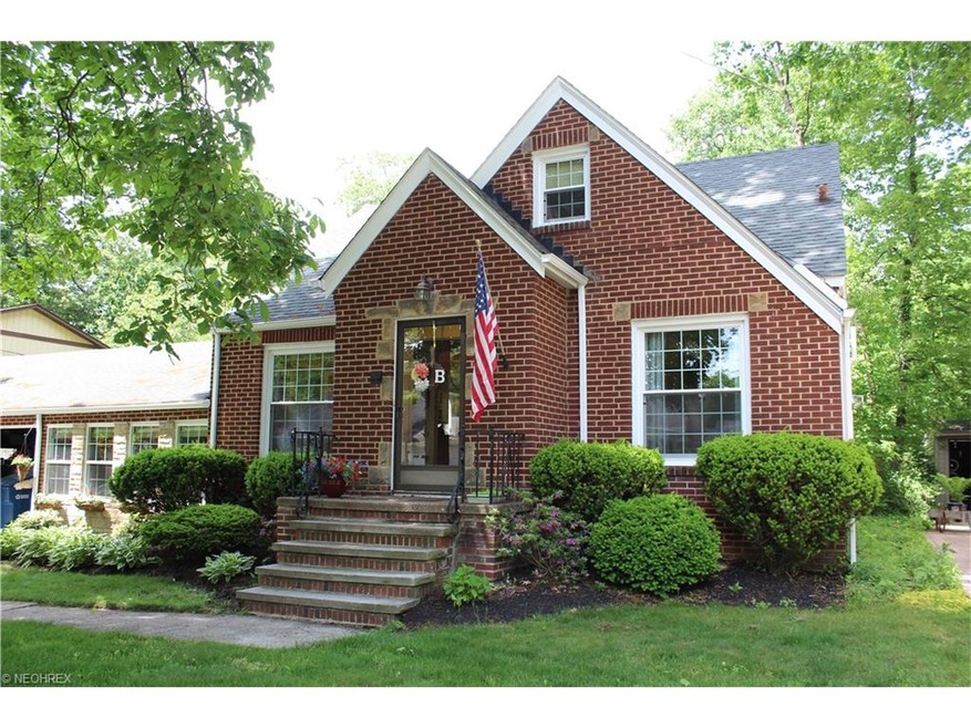 Brick front with large windows overlooking the fro