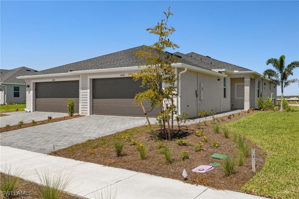 View of front of house featuring a garage, stucco