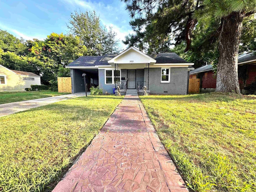 Single story home with concrete driveway, brick siding, crawl space, an attached carport, and a porch