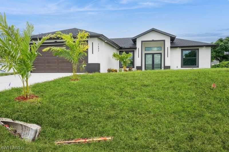 View of front of home featuring stucco siding, dri