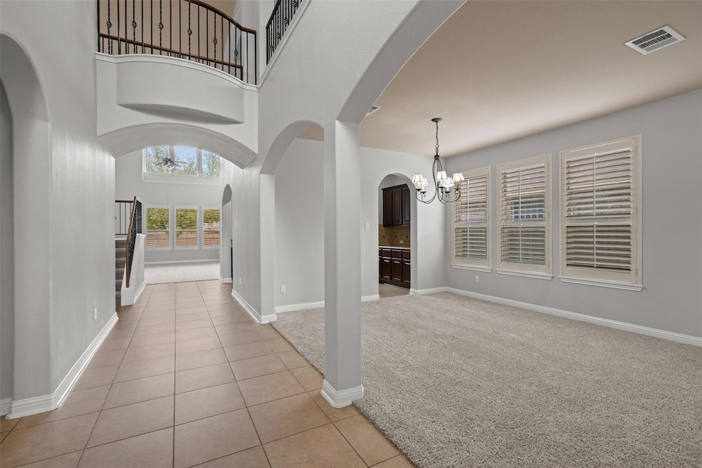 Entrance foyer with light colored carpet, visible