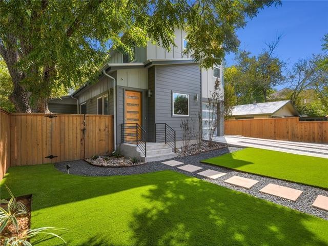The perfectly manicured front yard creates an invi