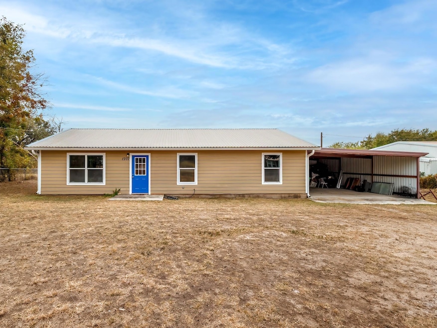 View of front of house featuring a carport