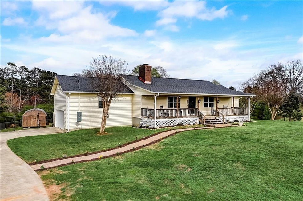 Ranch-style house featuring a porch, a front yard,