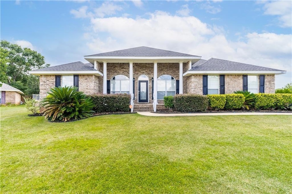 Neoclassical home featuring brick siding and a fro