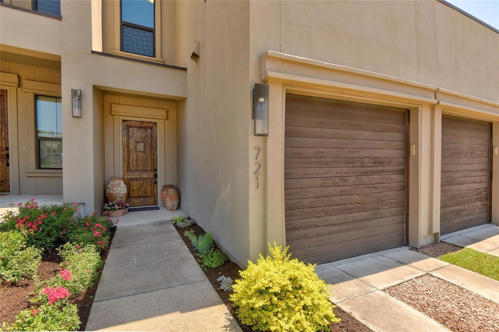 Doorway to property featuring a garage and stucco