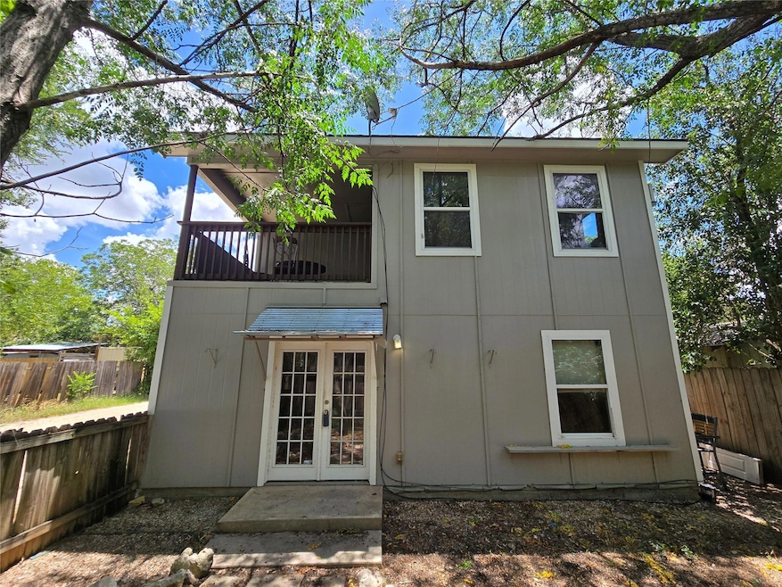 Rear view of house featuring french doors and a f