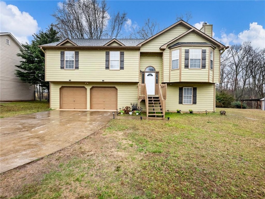 Raised ranch with a front yard, a chimney, concret