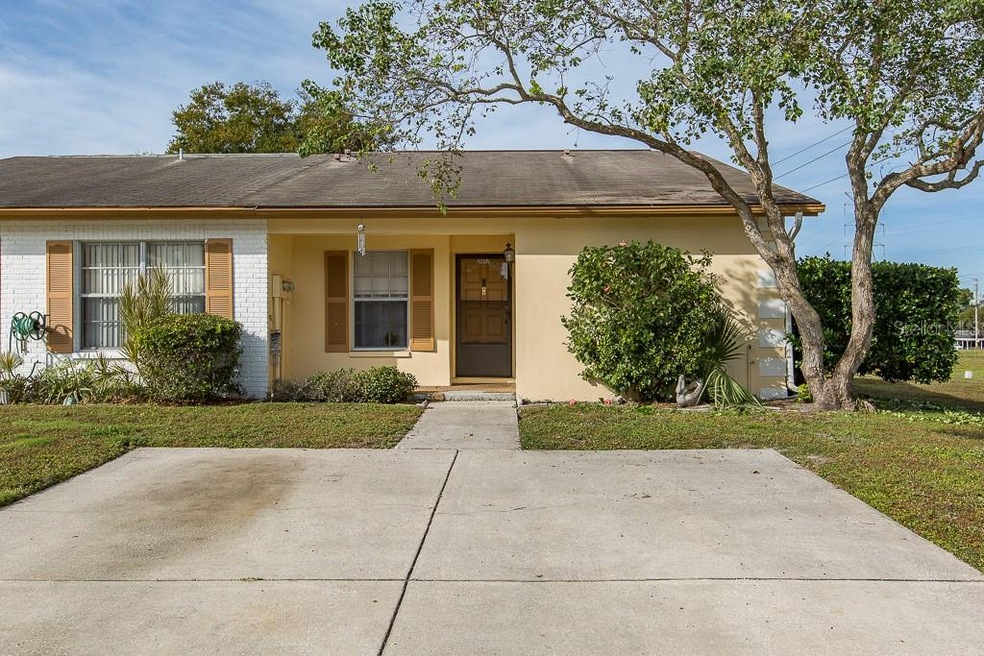 Front with 2 parking spaces, storm door and covere