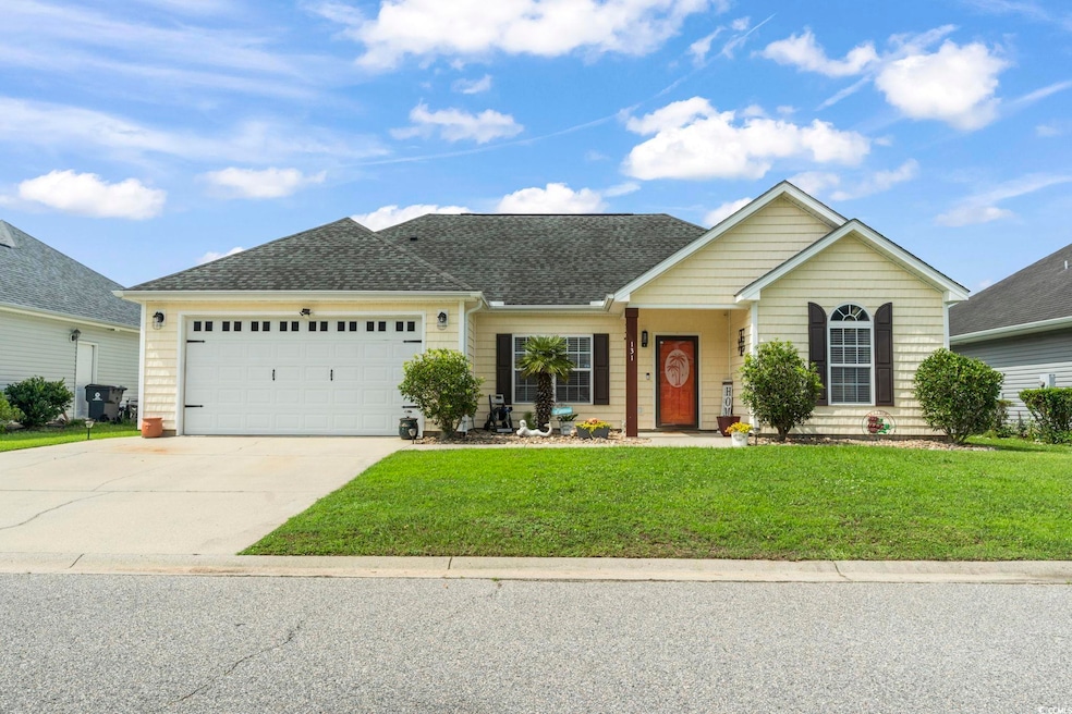 View of front of house featuring a front yard, a garage, driveway, and roof with shingles