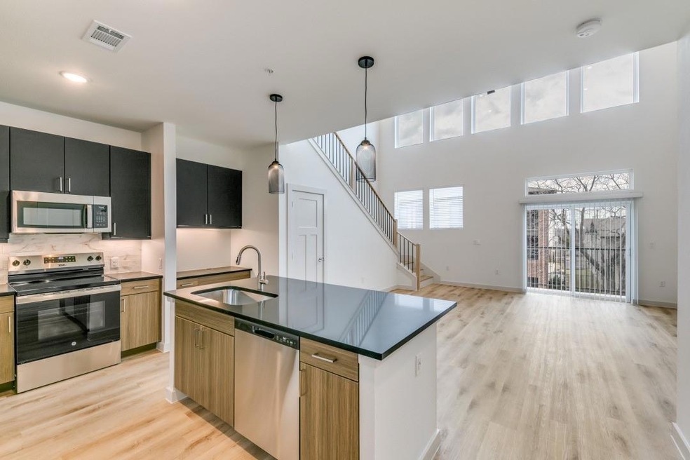 Kitchen with dark countertops, stainless steel app