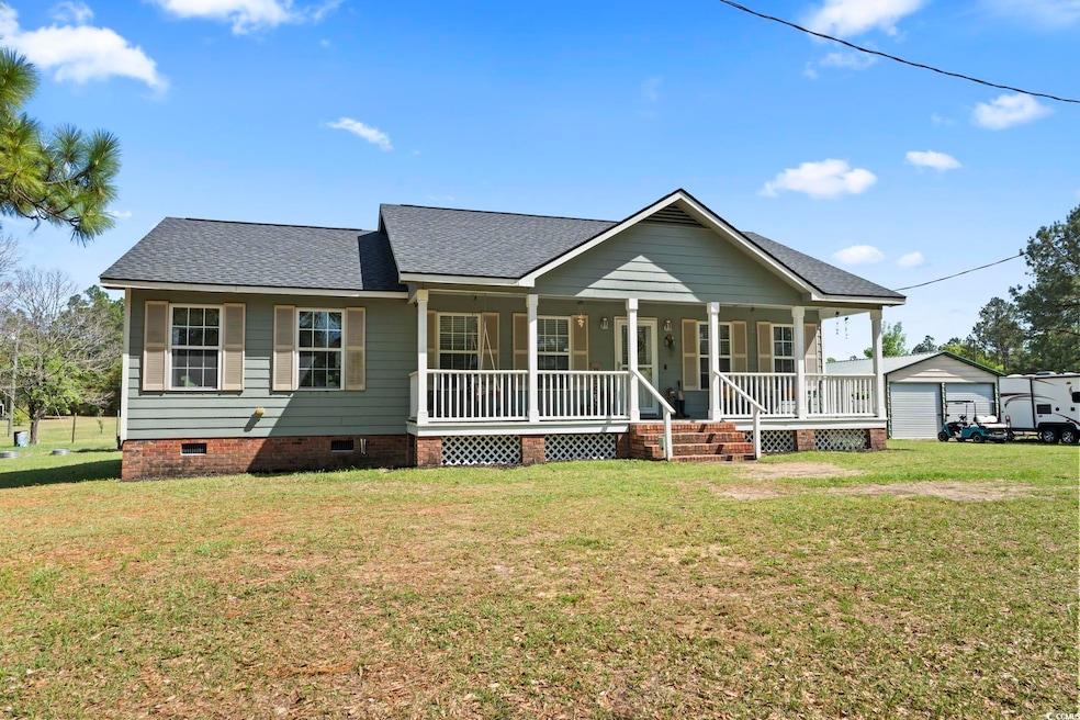 View of front facade with roof with shingles, crawl space, a front yard, a porch, and a garage
