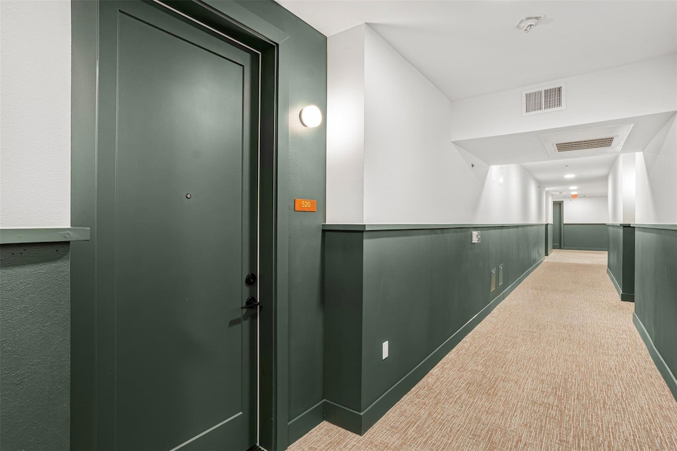 Corridor with visible vents and light carpet