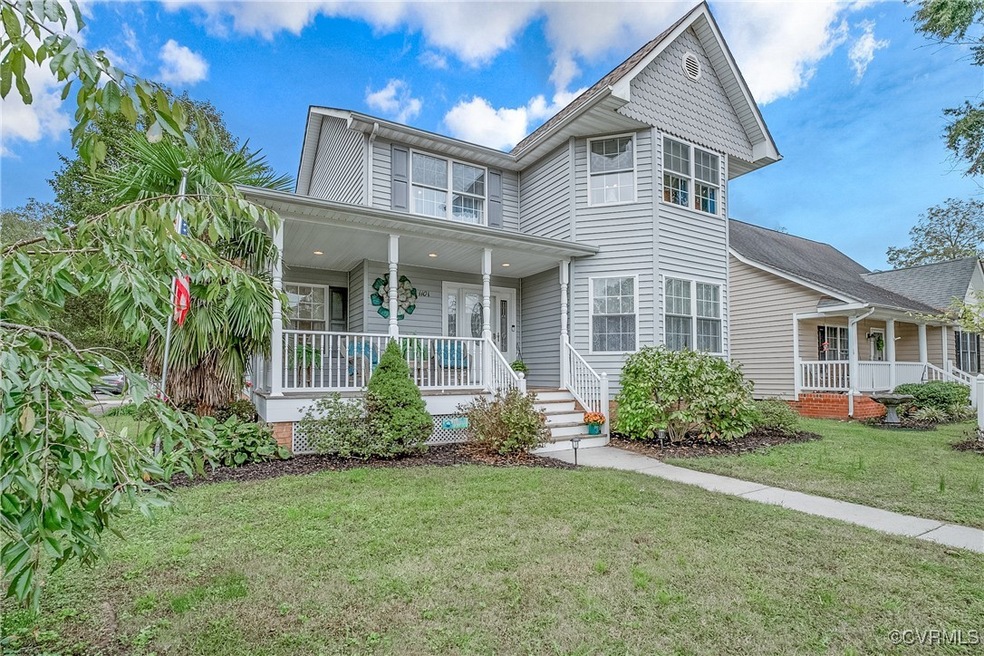 View of front of home with a front lawn and covere