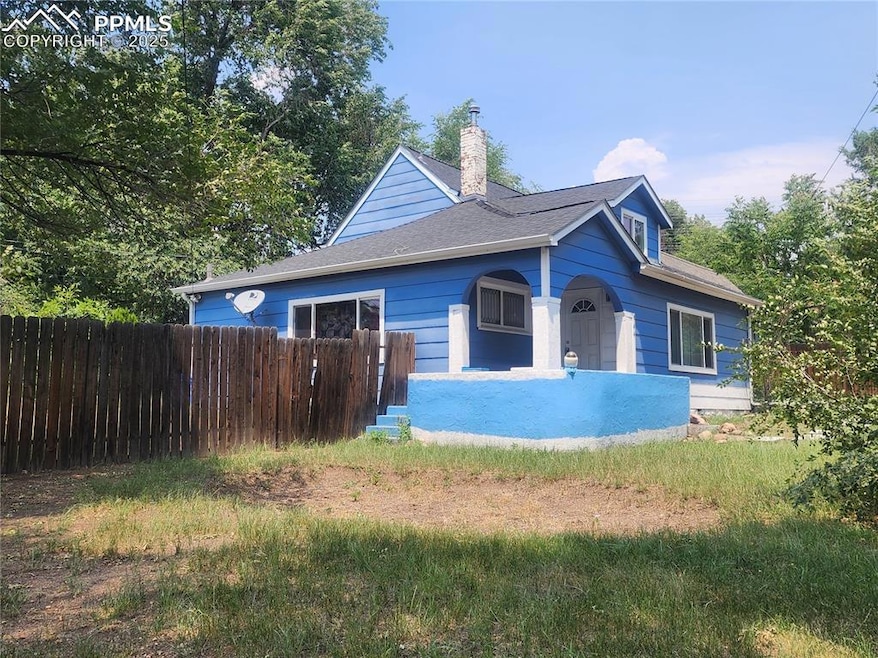 View of front of house with a chimney and a shingled roof