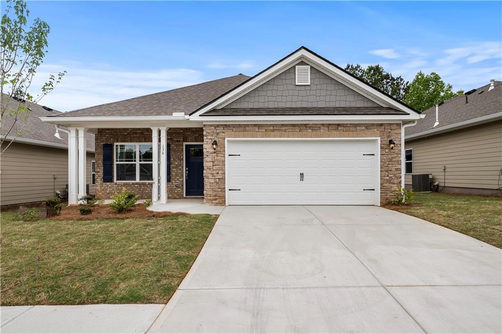 Craftsman-style house with a front yard, a garage,