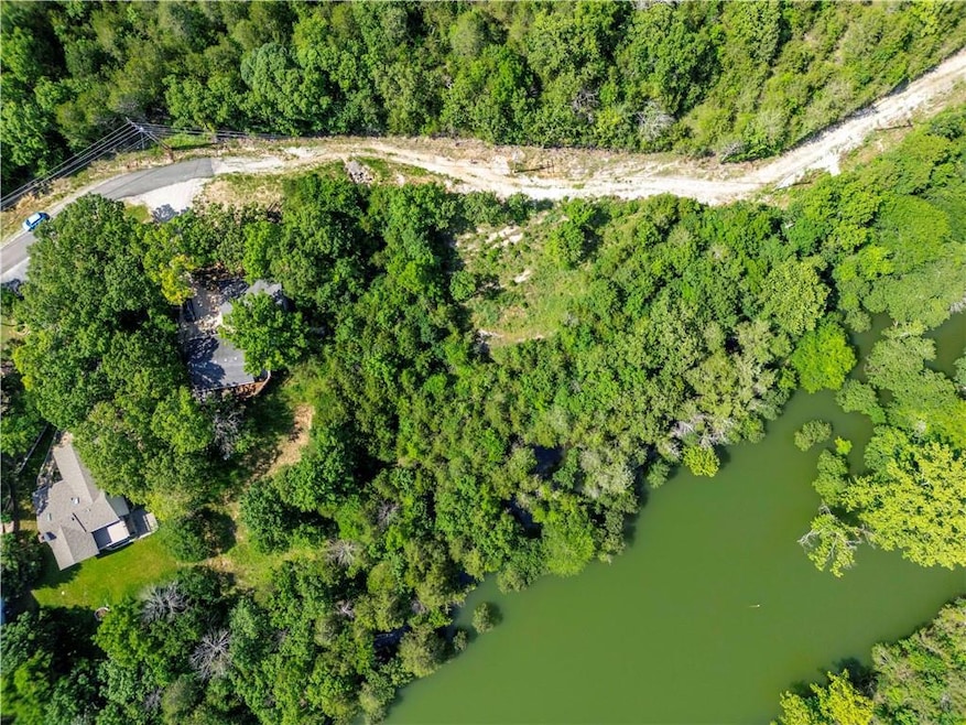Aerial view of property and surrounding area with a large body of water