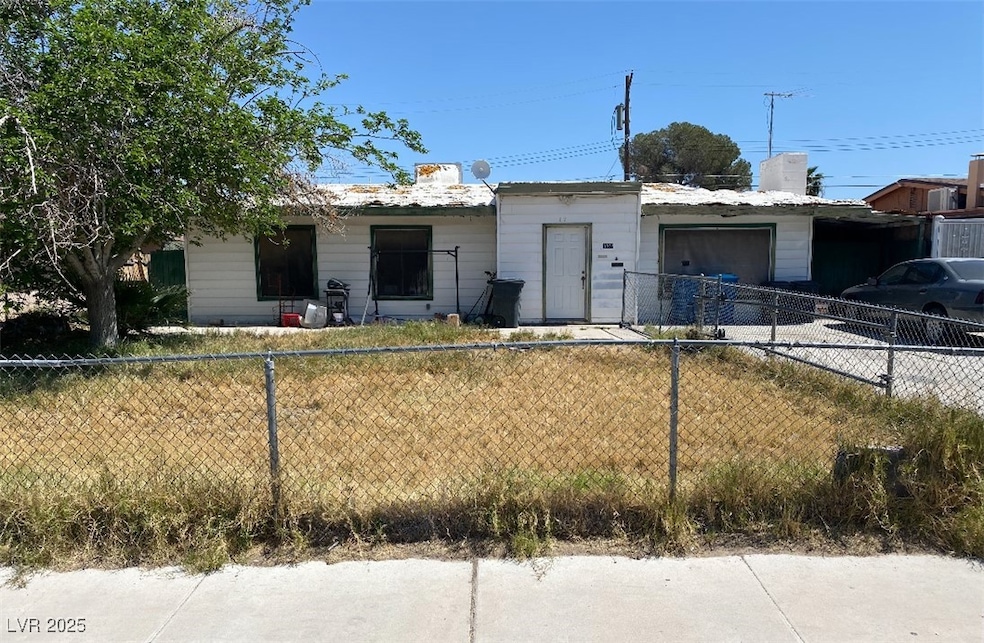 View of front of property featuring fence and an a