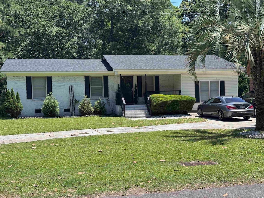 Ranch-style house with a porch, crawl space, a front yard, and roof with shingles