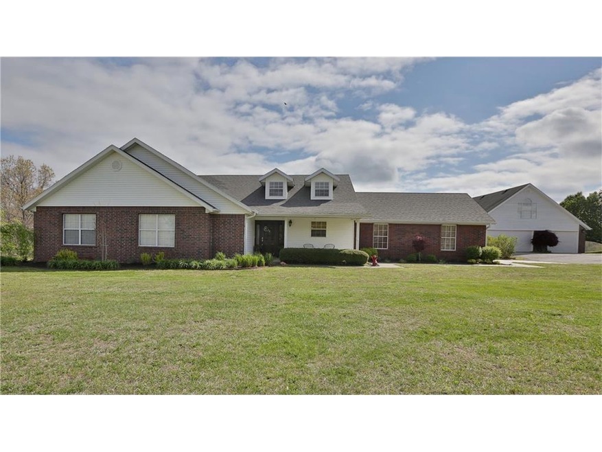 Brick and vinyl siding with a 3-car detached garage.
