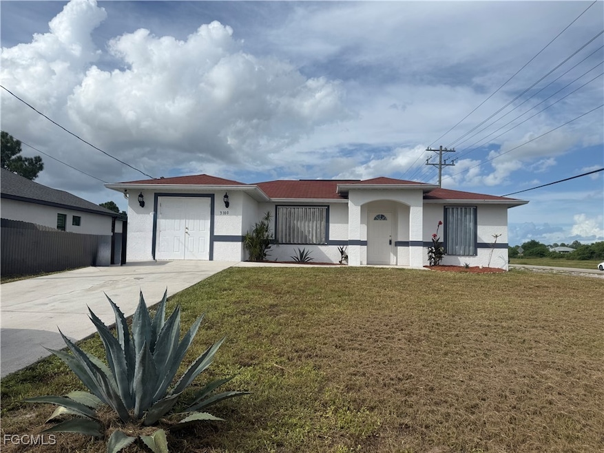 Ranch-style house featuring stucco siding and concrete driveway