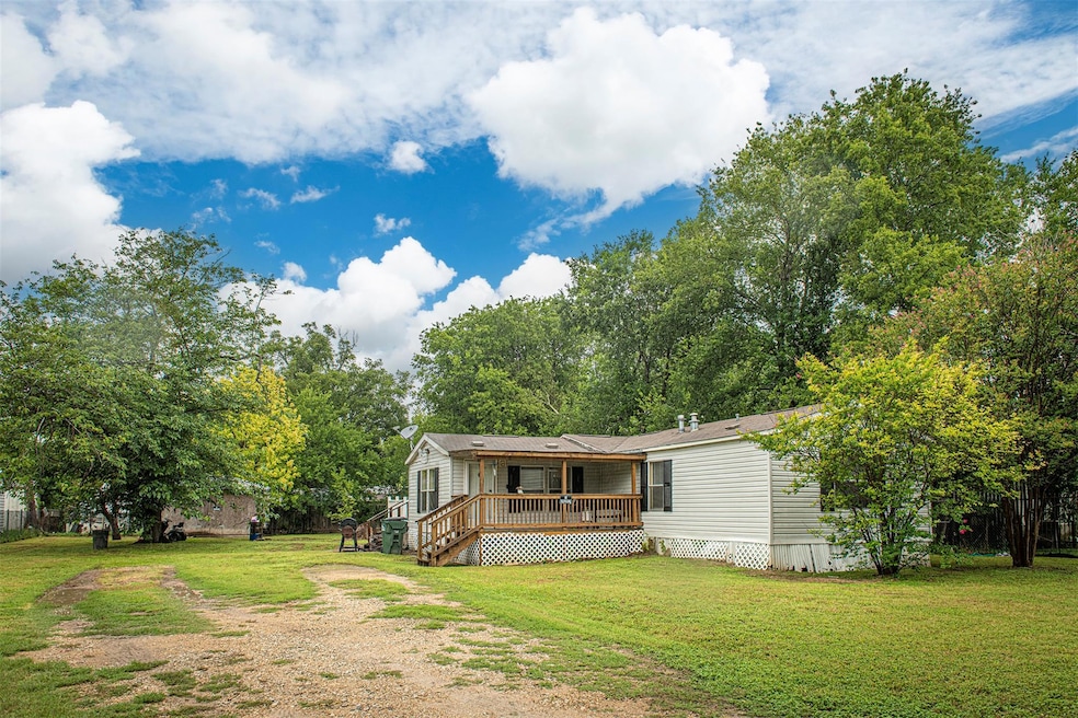 Manufactured / mobile home with a deck, driveway,
