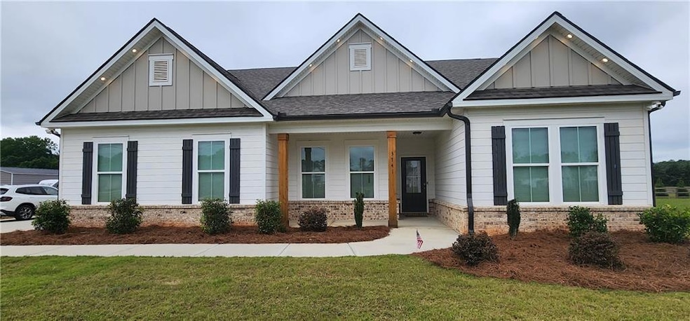 Craftsman inspired home with board and batten siding, a front yard, and a shingled roof