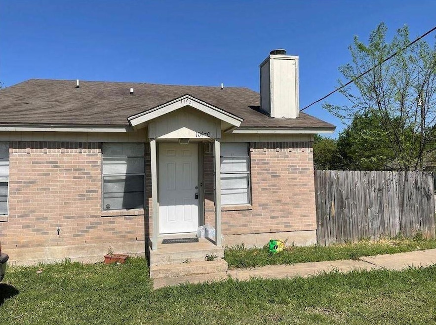 View of front of property with a chimney, brick s