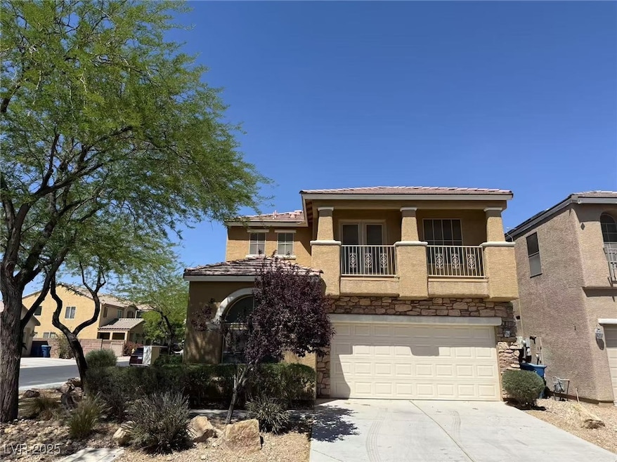 View of front of house featuring a balcony, stucco