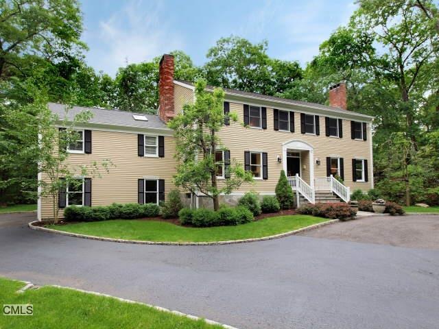 Circular driveway greets you at the front of this 