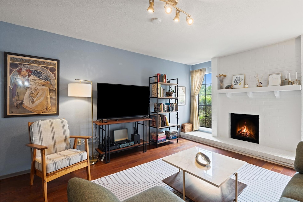 Living room with a brick fireplace and wood finis