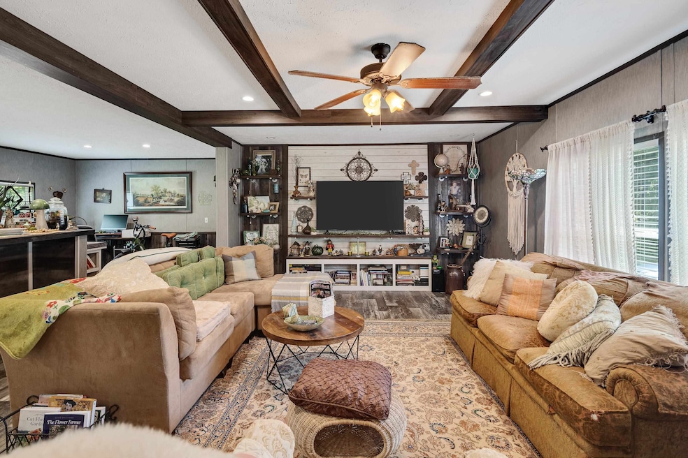 Living area featuring ceiling fan, beam ceiling, wood finished floors, a desk, and recessed lighting