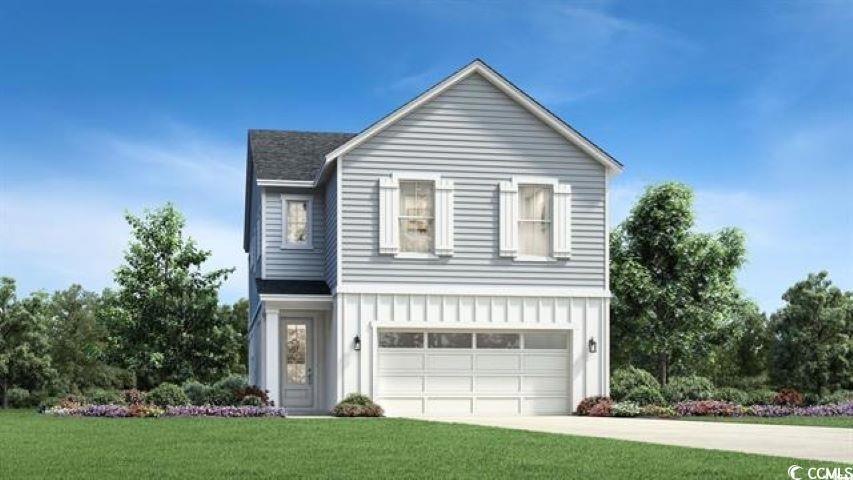 View of front of property featuring driveway, a ga