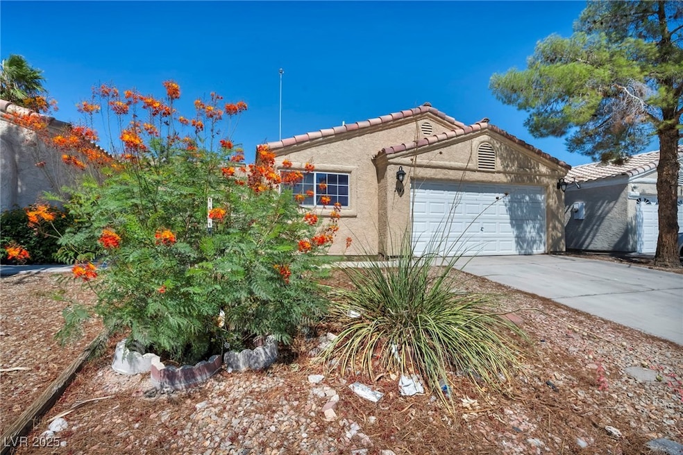 View of front of property with stucco siding, a ga