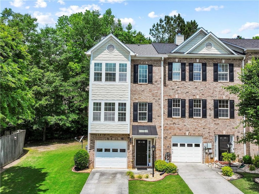 View of front facade with driveway, a garage, a ch