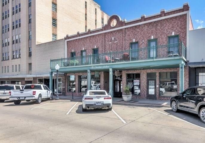 View of property with uncovered parking