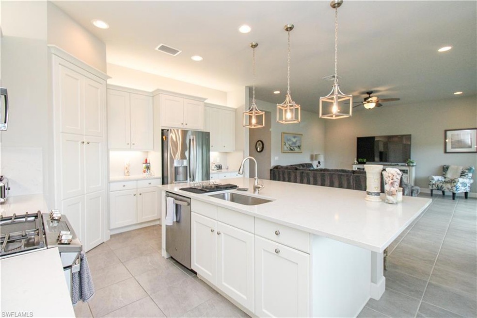 Kitchen with a kitchen island with sink, sink, cei