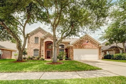 This beautifully designed Home is ideally located in Sunset Lakes - close to playgrounds and the multitude of this subdivisions amenities. 
Two mature oak trees shade the front of this attractive Home.