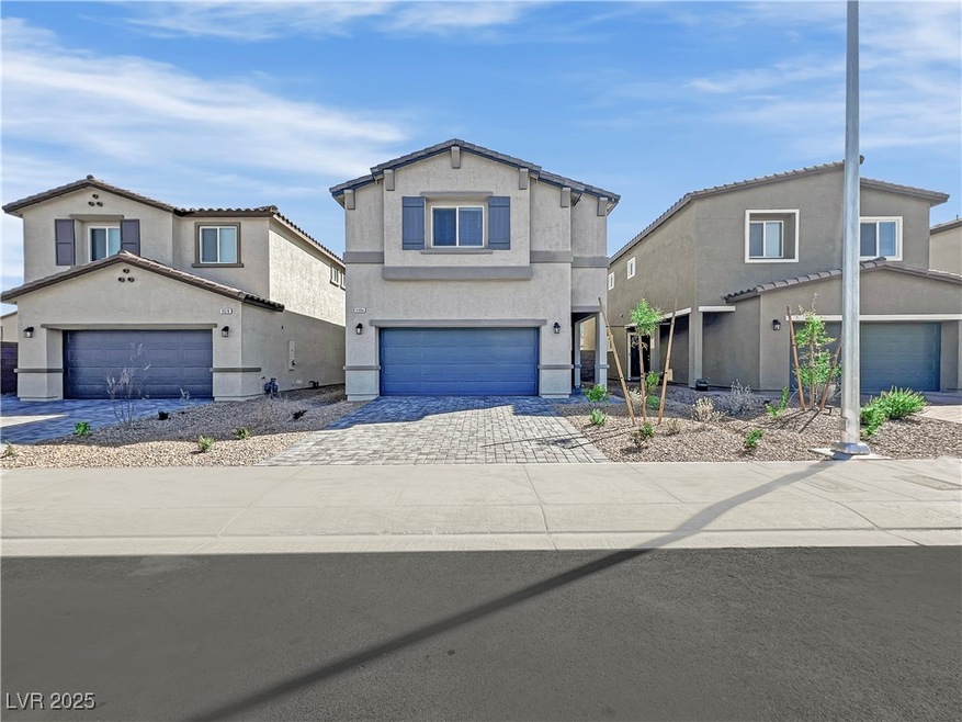 View of front facade featuring stucco siding, driv
