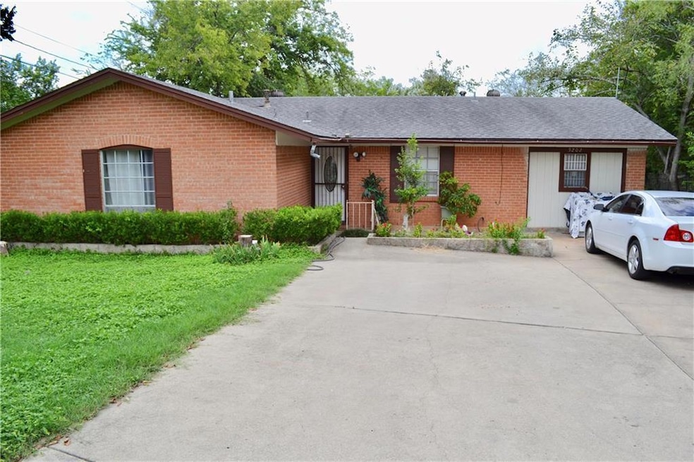 Single story home featuring roof with shingles, concrete driveway, a front lawn, and brick siding