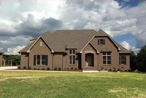 This brand new French Country home with soaring roofline has abundant 