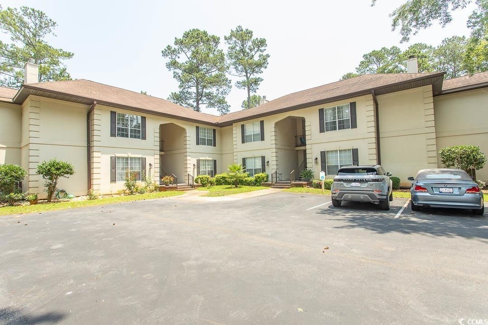 View of property with uncovered parking