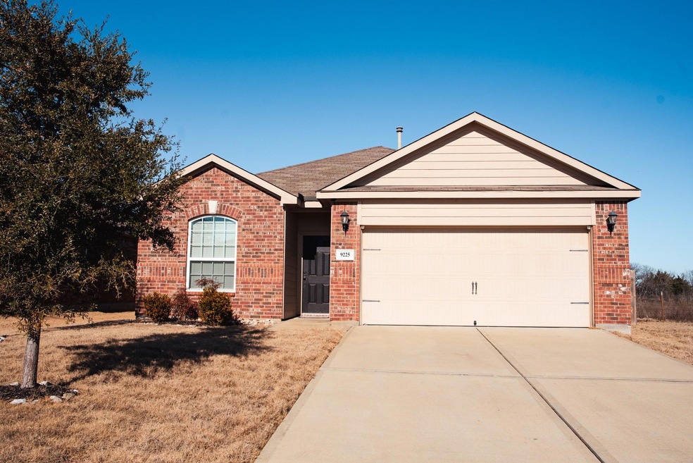Ranch-style home featuring a garage and a front ya