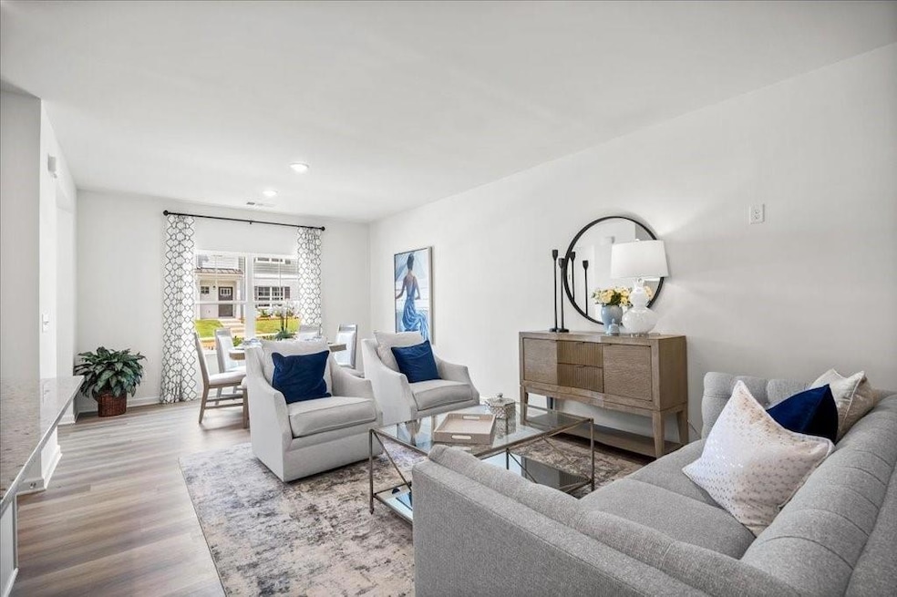 Living area with wood finished floors and recessed lighting