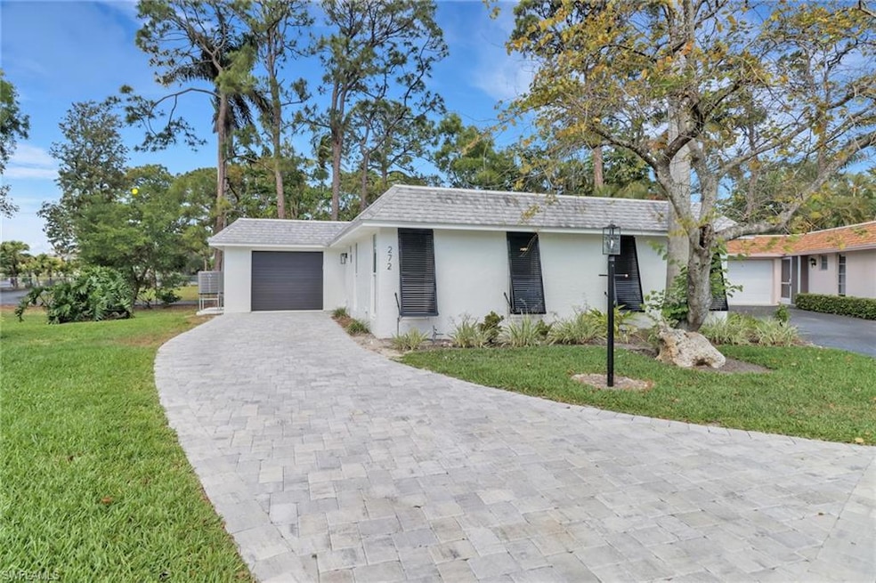 Single story home with a front yard, a garage, dec