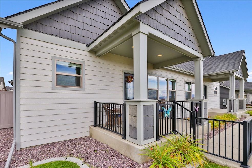 Entrance to property with roof with shingles