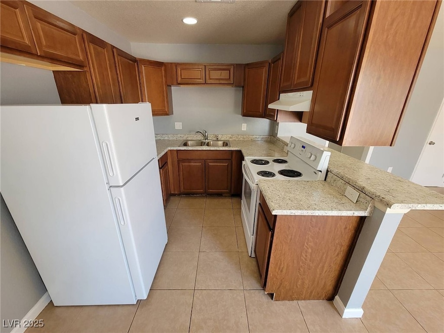 Kitchen featuring white appliances, under cabinet