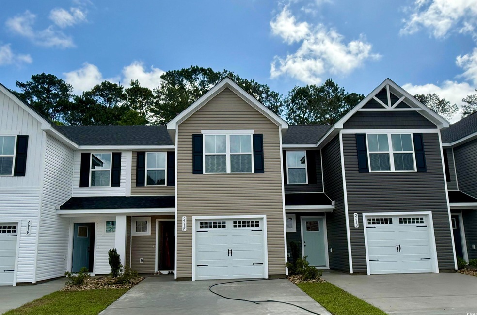 View of front of house with driveway, an attached garage, and roof with shingles