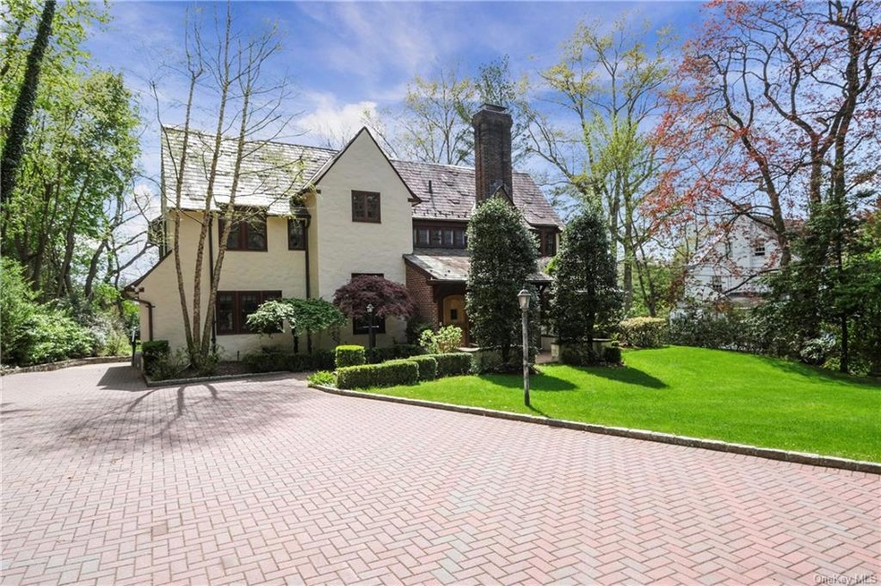 Stunning, stucco and brick Tudor with expansive, d